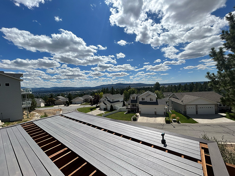 Decking in progress on a deck with views of the valley below.