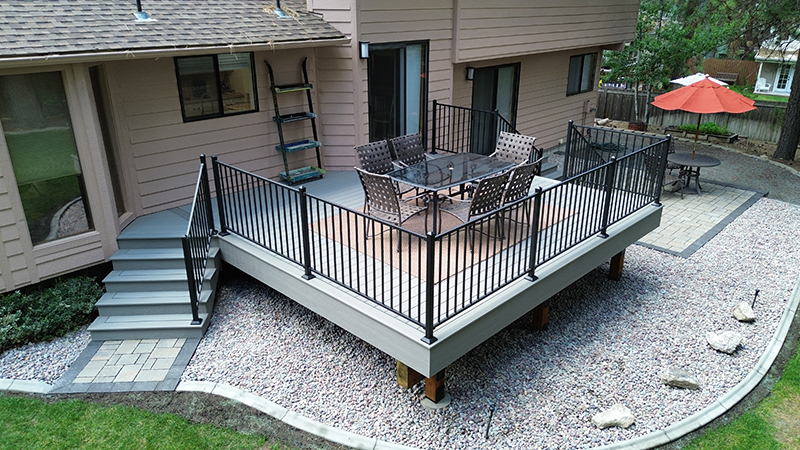 Beautiful back deck featuring two sets of steps for convenient access, blending style and functionality.