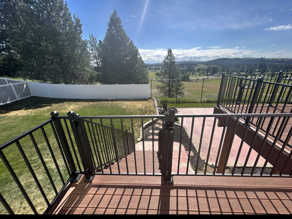 Composite deck with gate and railing overlooking a valley