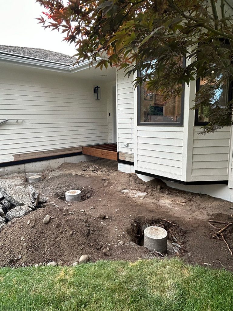 Concrete footings prepared for a front porch structure.
