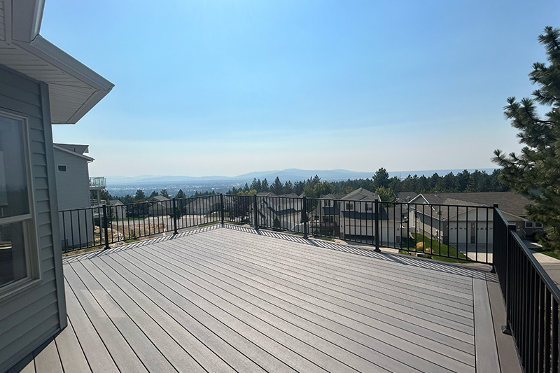 Beautiful deck overlooking the suburbs with distant mountain views.
