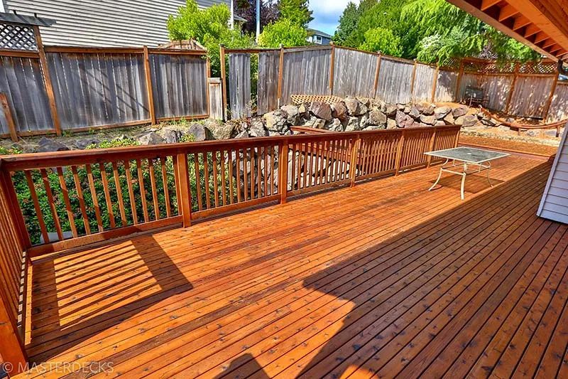 Large back deck built with stained cedar for a polished and natural look.