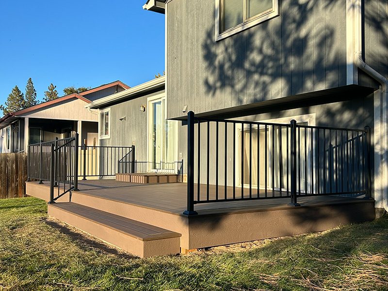 Composite deck with a box step, partially on the ground and partially elevated.