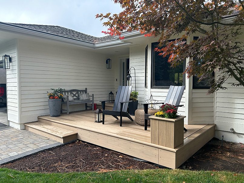 Front porch made of composite decking with a matching planter box.