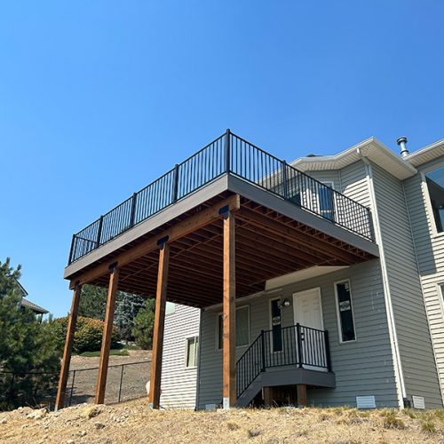 Showcasing a towering backyard deck designed for gatherings and outdoor living, blending beauty and functionality.